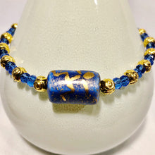 Blue and gold bracelet with stick figure man bead