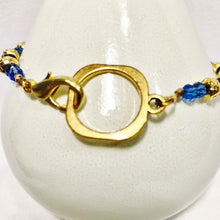 Blue and gold bracelet with stick figure man bead