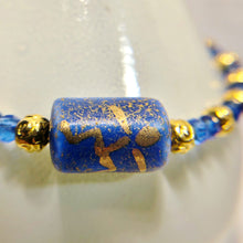 Blue and gold bracelet with stick figure man bead