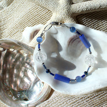 Bracelet featuring blue crackle-glass beads and silver trim