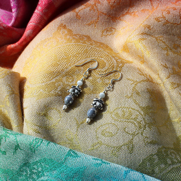 Earrings with silver bunny charms and lavender-colored swirl beads