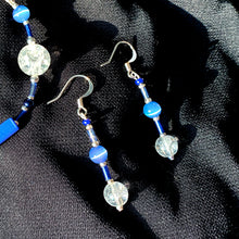 Earrings featuring blue crackle-glass beads and silver trim