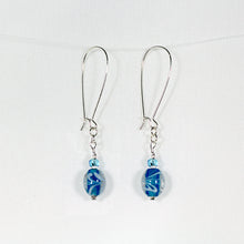 Earrings with turquoise-colored swirl glass beads