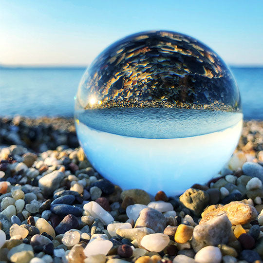 Crystal ball on rocky sea shore