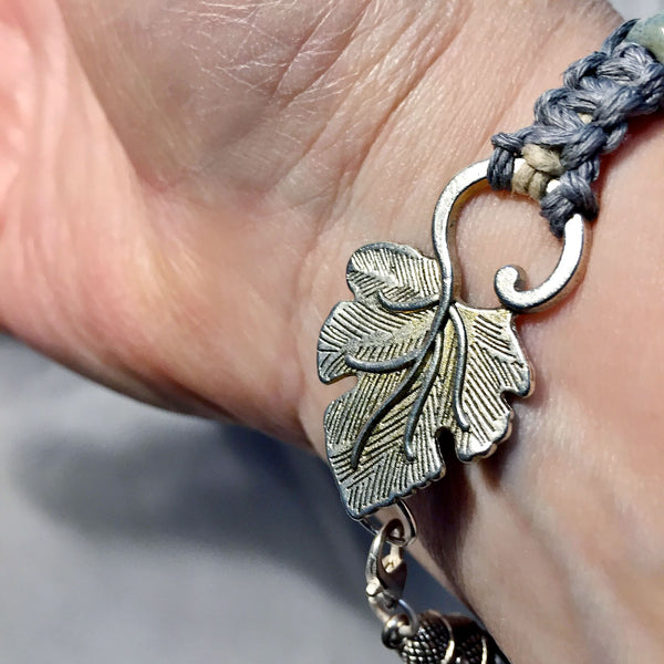 Grey macrame bracelet with ceramic beads and leaf clasp