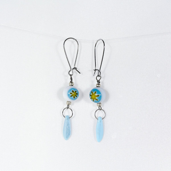 Earrings featuring handblown glass beads with sunshine blue sky design