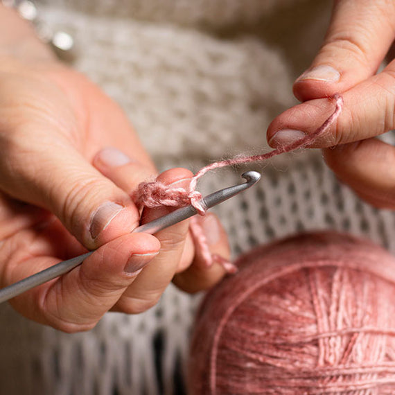 Woman knitting handmade clothing