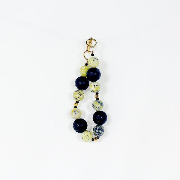 Bracelet featuring yellow kiwi jade and black lava beads - youth size